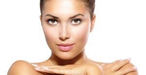 a woman poses to show off her makeup and tan