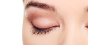 a woman dislays her shapely eyebrows