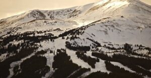a landscape view of a mountain and its many ski runs