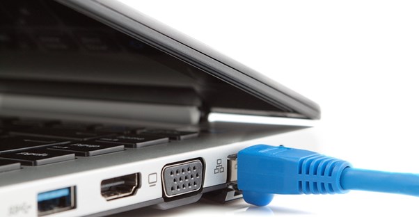 An Ethernet cable plugged into a computer using service from a ranked internet provider.