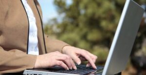 A woman works on her laptop that is using mobile internet service
