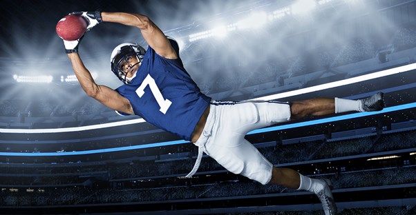 a fantasy football player diving for the end zone