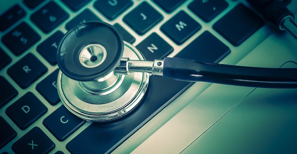 A stethoscope on a keyboard to represent protection offered with extended laptop warranty.