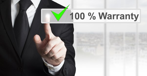 A man touches the 100 percent warranty button on a touchscreen.