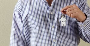 Man in Gingham Shirt With Key
