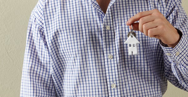 Man in Gingham Shirt With Key