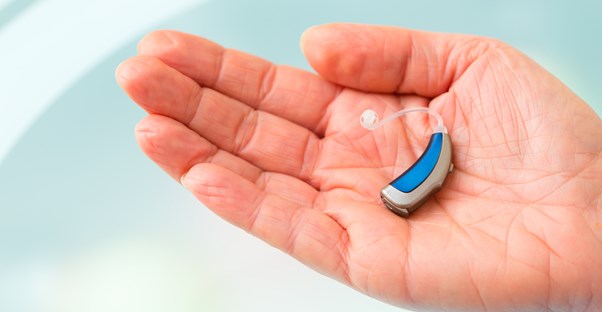 a man caring for his hearing aid