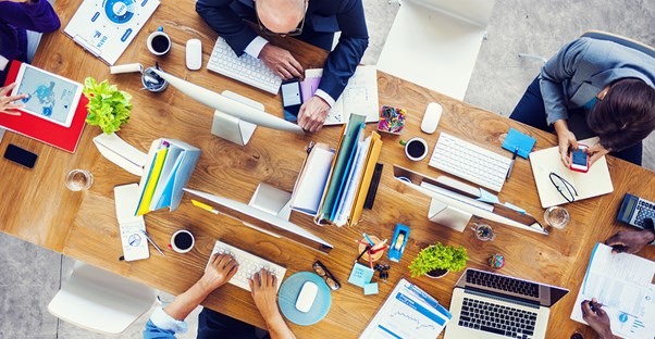 Busy Business People At a Table with Coffee