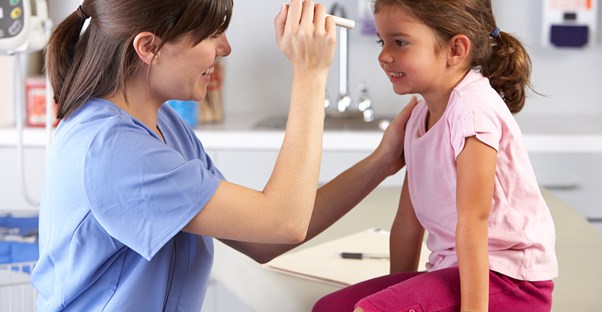 CNA checks the sight of a young girl