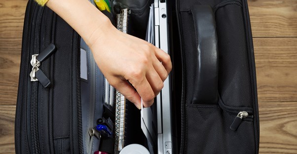 a business traveler enjoys a new gift of a travel bag