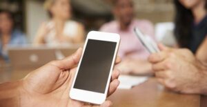 A student using a cell phone to cheat in school