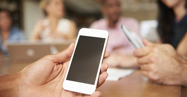 A student using a cell phone to cheat in school