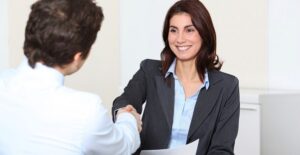 An HR manager smiles as she negotiates her salary