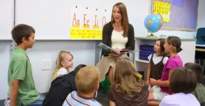 A substitute teacher reads to young children