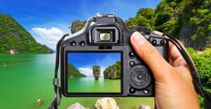 a photographer centers a picture with the viewfinder