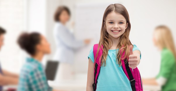 Student gives the camer a big smile and a thumbs up
