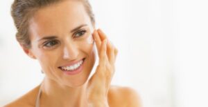 forty year old woman smiles using anti-aging products because she still looks twenty five
