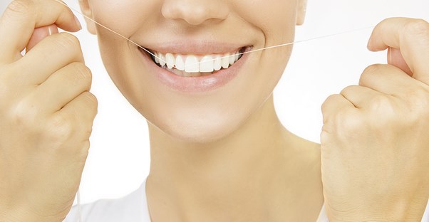a woman using floss