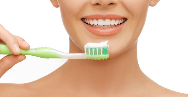 a woman using toothpaste