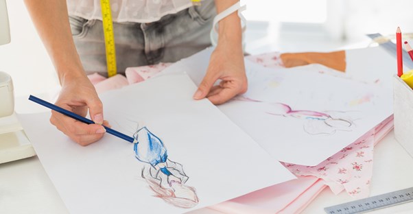 A fashion designer sketches