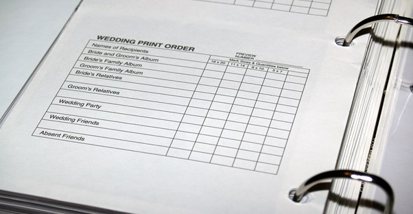 A wedding binder containing information over wedding invitations