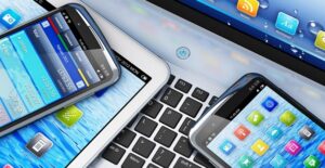 Phones, tablets, and phablets sitting on top of a computer