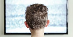 A little boy watching an lcd tv