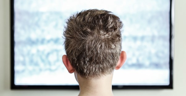 A little boy watching an lcd tv