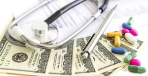 Pills, stethoscope, and dollar bills