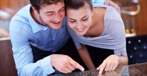 A couple shops for engagement rings and discusses budget.