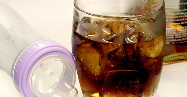 a bottle of alcohol and a baby bottle, representing fetal alcohol syndrome