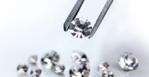 A jeweler choosing the perfect diamond for an engagement ring