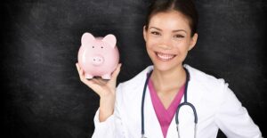 Doctor holding piggy bank