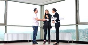 Real estate agent closes a deal with a young couple purchasing a home