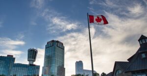 a canadian flag flies above the canada side of niagara falls