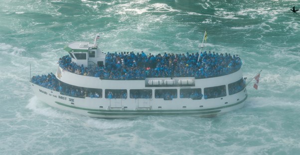 a boat takes visitors up close to niagara falls