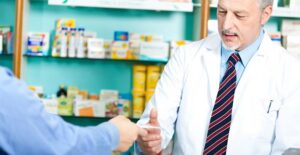 a man handing a doctor a list of erectile dysfunction symptoms