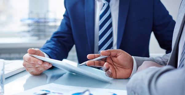 Project manager points something out on paper
