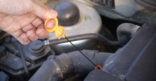 A car owner changing the oil in his car