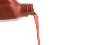 Transmission fluid being poured into a car