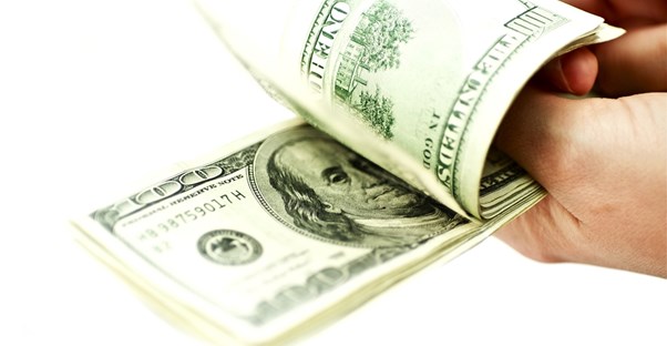Stack of $100 bills about to become a money order