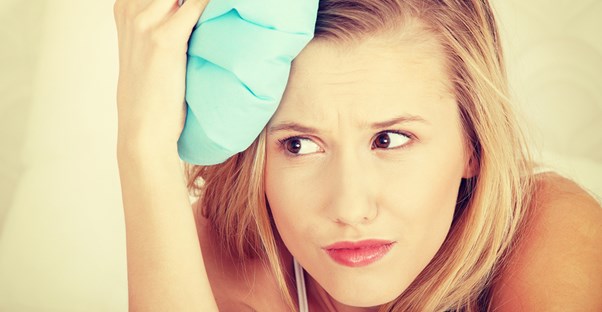 Woman trying a home remedy for migraines