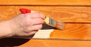 A man painting outdoor furniture himself