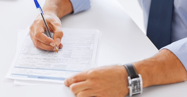 Man signing a title insurance policy