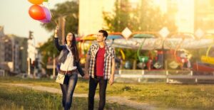a couple walks hand in hand enjoying their first date