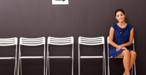 Girl in a dress sits and waits for her job interview