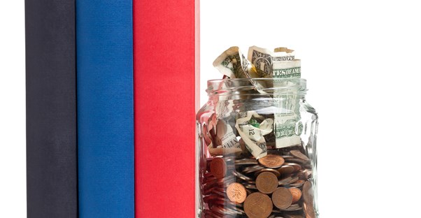 Binders next to a jar of change