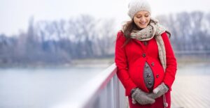Pregnant woman showing of her maternity wardrobe