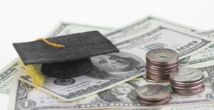 Money with a miniature graduation cap