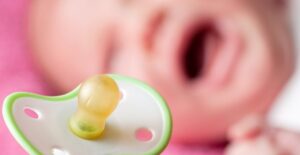 A baby crying because it wants a pacifier